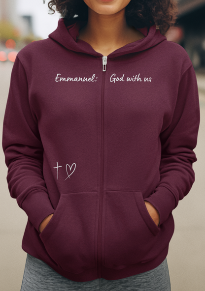 This Unisex Heavy Blend™ Full Zip Hooded Sweatshirt features the words Emmanuel God With Us on the upper chest and an image of a cross with a heart above the pocket.