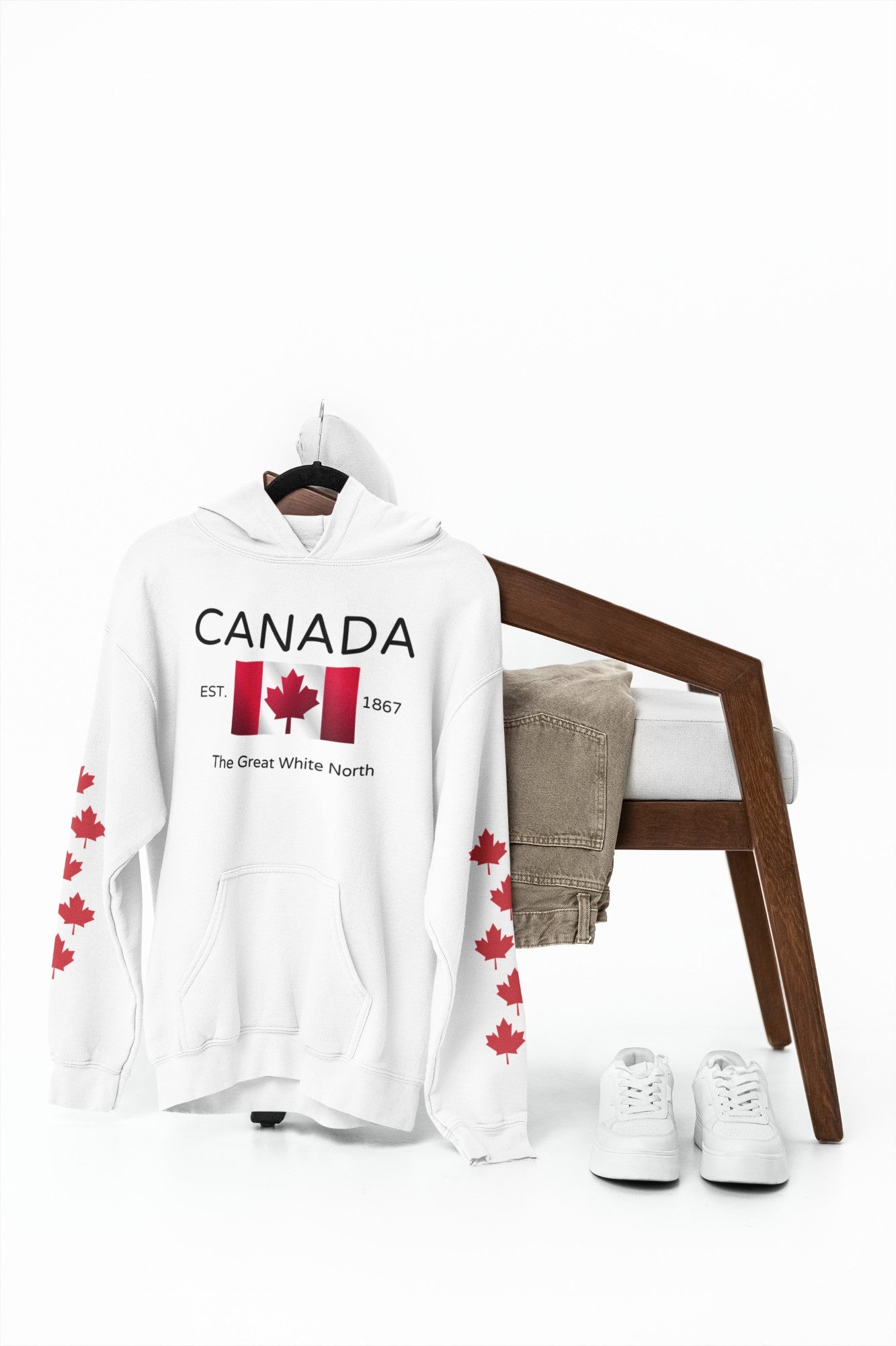 On the front of this custom unisex patriotic sweater is a Canadian flag that looks like it is flying in the wind, the words Canada The Great White North are underneath the flag with the word Est on the right side of the flag with the number 1867 being on the left side of the flag. Each are has red maple leaves that run down each sleeve to the cuff.