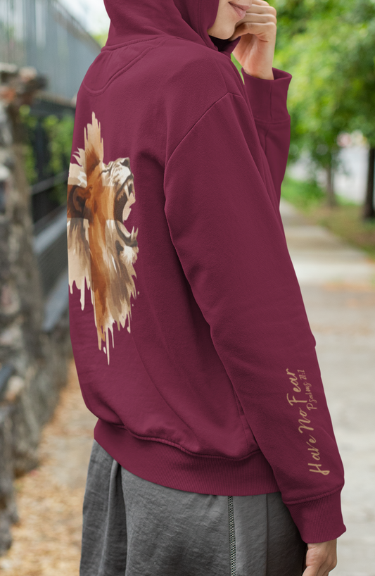 This custom Christian unisex hoodie features a image of a majestic male lion roaring with a Jesus cross overlayed overtop of the lion on the back of the hoodie, the bible verse Have No Fear Psalms 27:1 is on the right sleeve in gold cursive font.