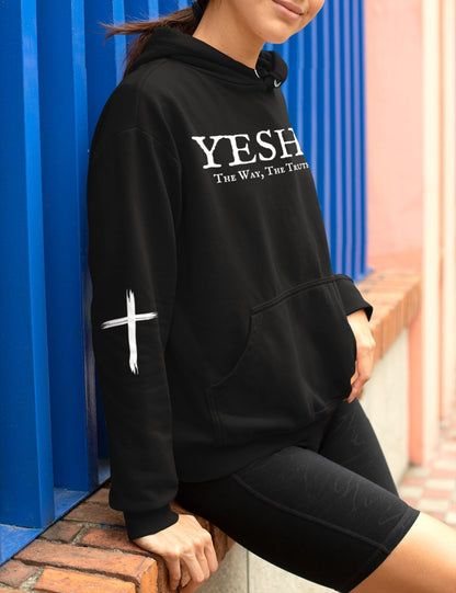 A oversized hoodie, on the front of the hoodie in white are the words Yeshua the same today tomorrow and forever in a old style font, there is also a white Jesus cross on both sleeves of the hooded sweater