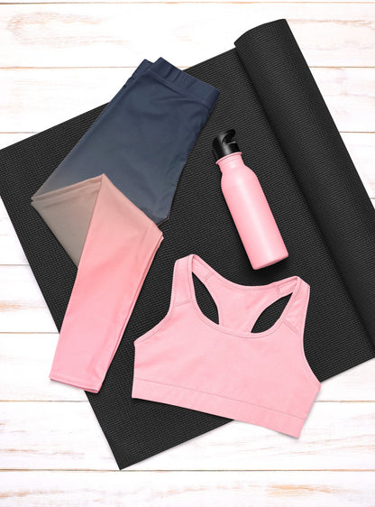 A pair of custom handmade high waisted women's leggings that have a ombre pattern that starts as navy blue at the top waistline of the leggings then fades to a light bubble gum pink at the ankles of the pants.