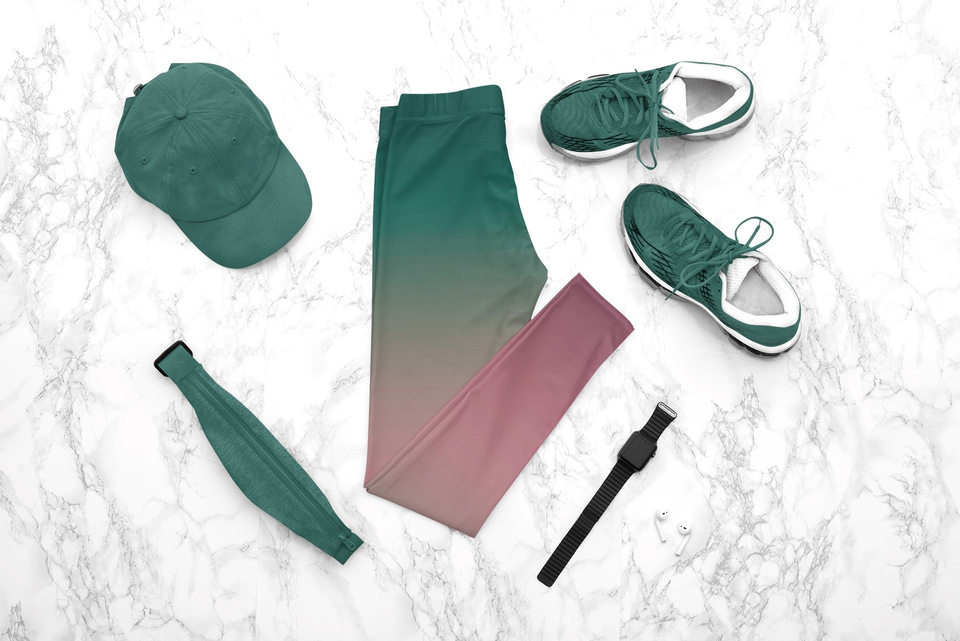 A pair of custom handmade high waisted women's leggings with an ombre pattern that starts as an emerald green at the top then fades to a light purple, then to a deep purple at the ankle of the pant.