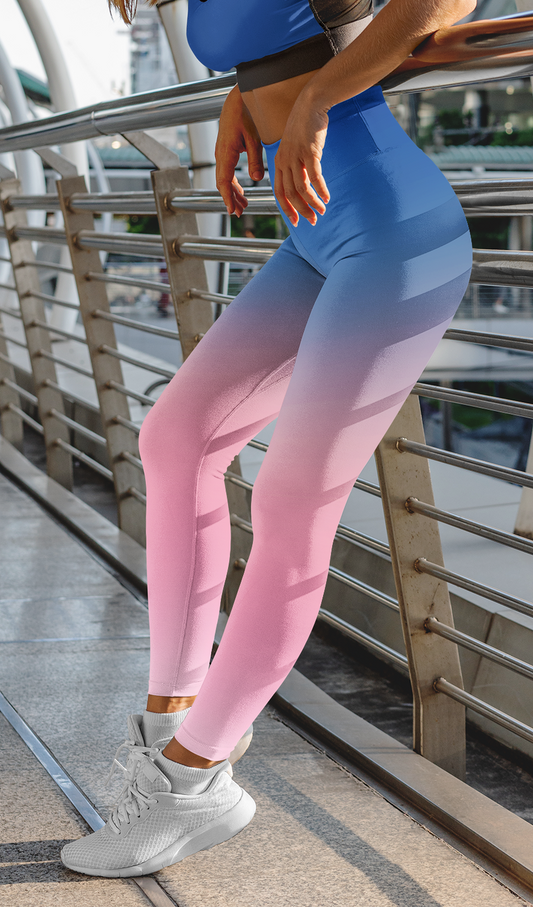 Custom high waisted women's leggings with an ombre pattern starting with an ocean blue at the waistline then it fading to a bubble gum pink at the bottom.