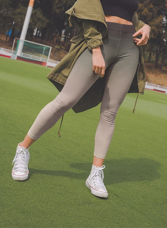 This custom handmade women's high waisted legging has an ombre pattern starting as black on the waistline then fading to a light beige color at the ankle of the pants.