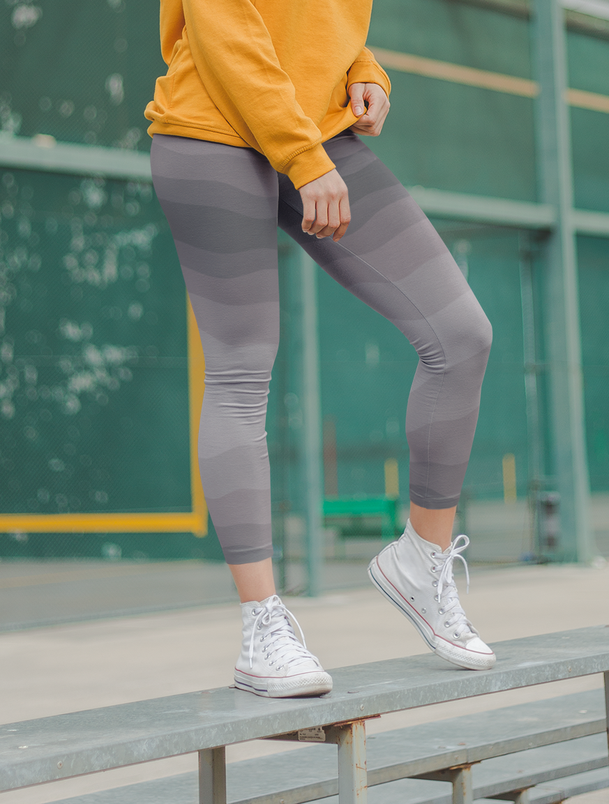 Custom high waisted women's leggings that have a wavy lines pattern that are all different shades of grey.