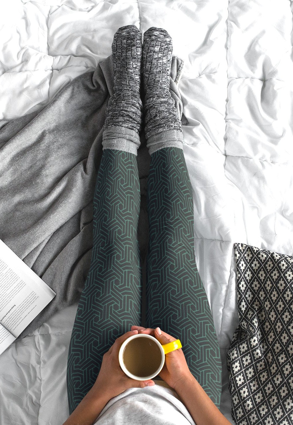 These custom handmade women's high waisted leggings are black in color with a glowing green geometric pattern overlayed on the top.