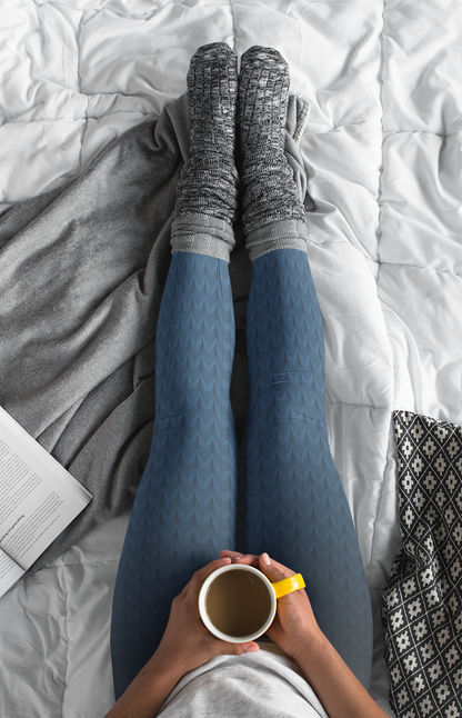 A pair of high waisted women's handmade custom leggings with a ombre pattern that starts as black at the waistline then shifts to a deep blue color at the bottom, there is a black wave pattern that is superimposed overtop and it blends into the black at the waistline.