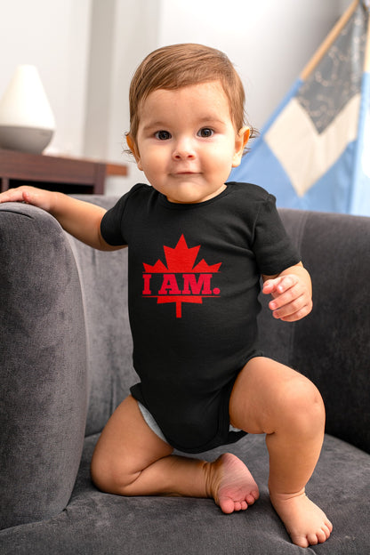 On the front of this custom infant short sleeve onesie is a image of a Canadian Maple leaf with the words I AM in the center of it in large block letters.