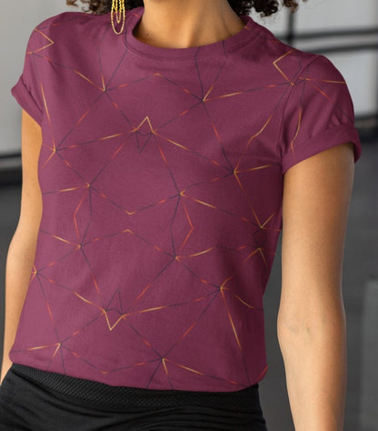 This custom designed handmade women's t-shirt is maroon in color with gold lines throughout the shirt in a geometric patterns, the lines are different shades of gold making it look like it is glowing on the shirt.