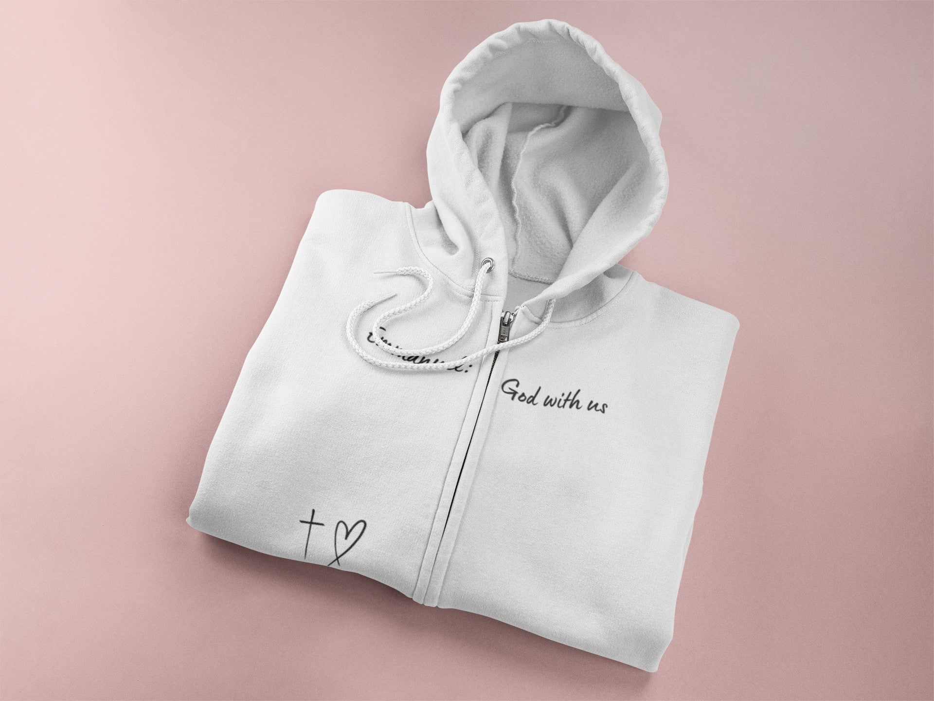 This Unisex Heavy Blend™ Full Zip Hooded Sweatshirt features the words Emmanuel God With Us on the upper chest and an image of a cross with a heart above the pocket.