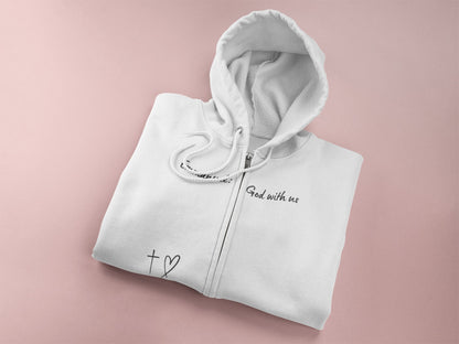 This Unisex Heavy Blend™ Full Zip Hooded Sweatshirt features the words Emmanuel God With Us on the upper chest and an image of a cross with a heart above the pocket.
