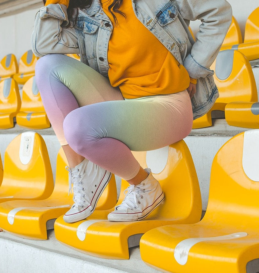 A pair of custom women's high waisted leggings with a soft gradient rainbow pattern all over the pants from top to bottom.