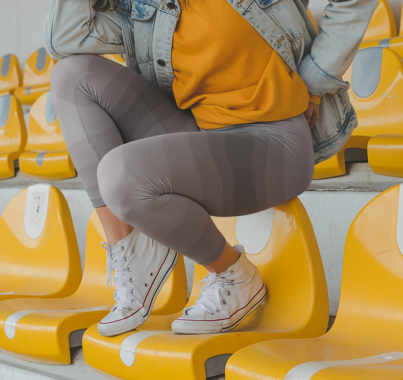 Custom high waisted women's leggings that have a wavy lines pattern that are all different shades of grey.