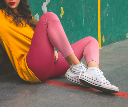 These custom handmade women's high waisted leggings have a pink ombre design with the top of the pants being a dark pink then it fading to a light baby pink at the ankles of the pants.