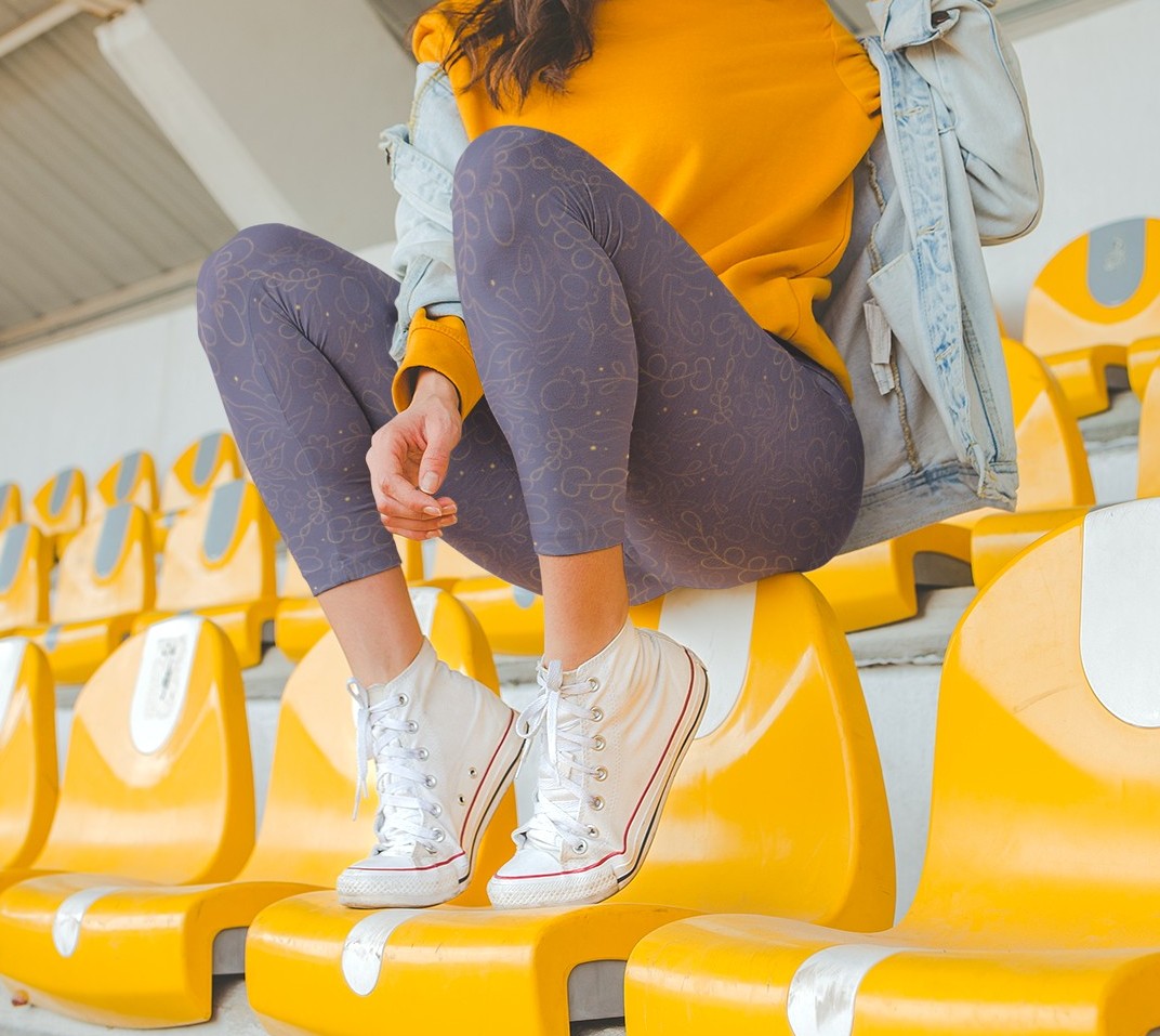 These custom handmade women's leggings are a dark purple with a beautiful gold floral pattern overlayed on the top.