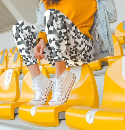 A  pair of women's handmade custom high waisted leggings, the leggings have a black, grey and white geometric pattern all across the entire pair of workout leggings.