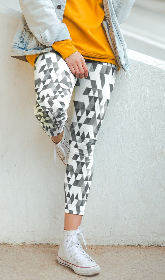 A  pair of women's handmade custom high waisted leggings, the leggings have a black, grey and white geometric pattern all across the entire pair of workout leggings.