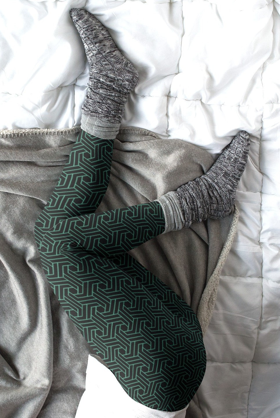 These custom handmade women's high waisted leggings are black in color with a glowing green geometric pattern overlayed on the top.