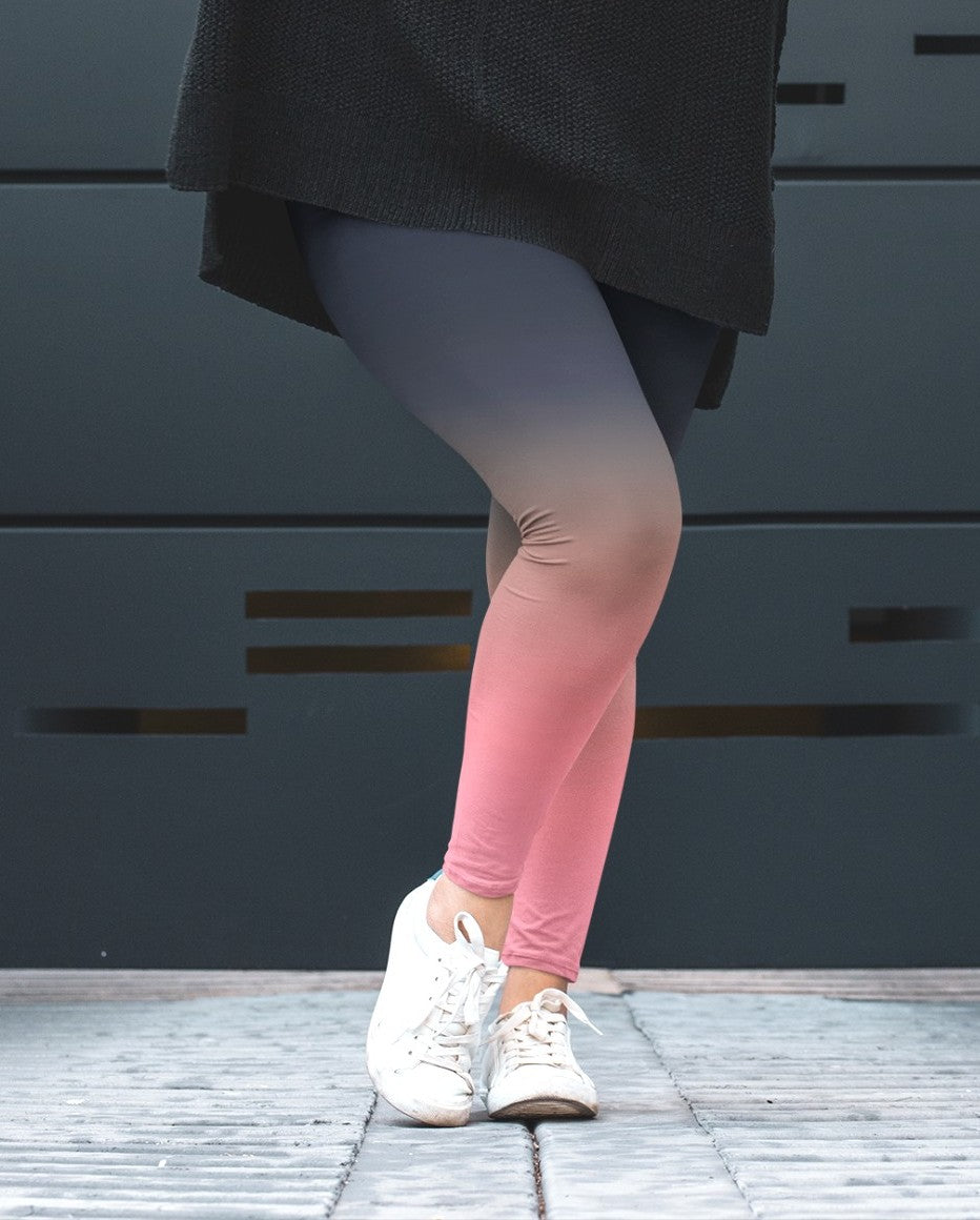 A pair of custom handmade high waisted women's leggings that have a ombre pattern that starts as navy blue at the top waistline of the leggings then fades to a light bubble gum pink at the ankles of the pants.