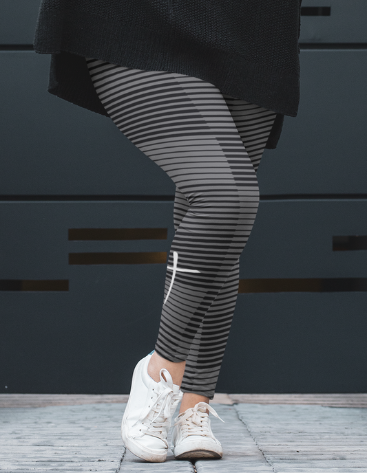 A pair of women's high waisted Christian themed leggings, the pants are light grey  color with black stripes running across the pants, the lines are in different thicknesses from the top to the bottom ankle of the leggings giving it a 3D look when worn, there is a white Jesus cross on the bottom right calf of the pant.