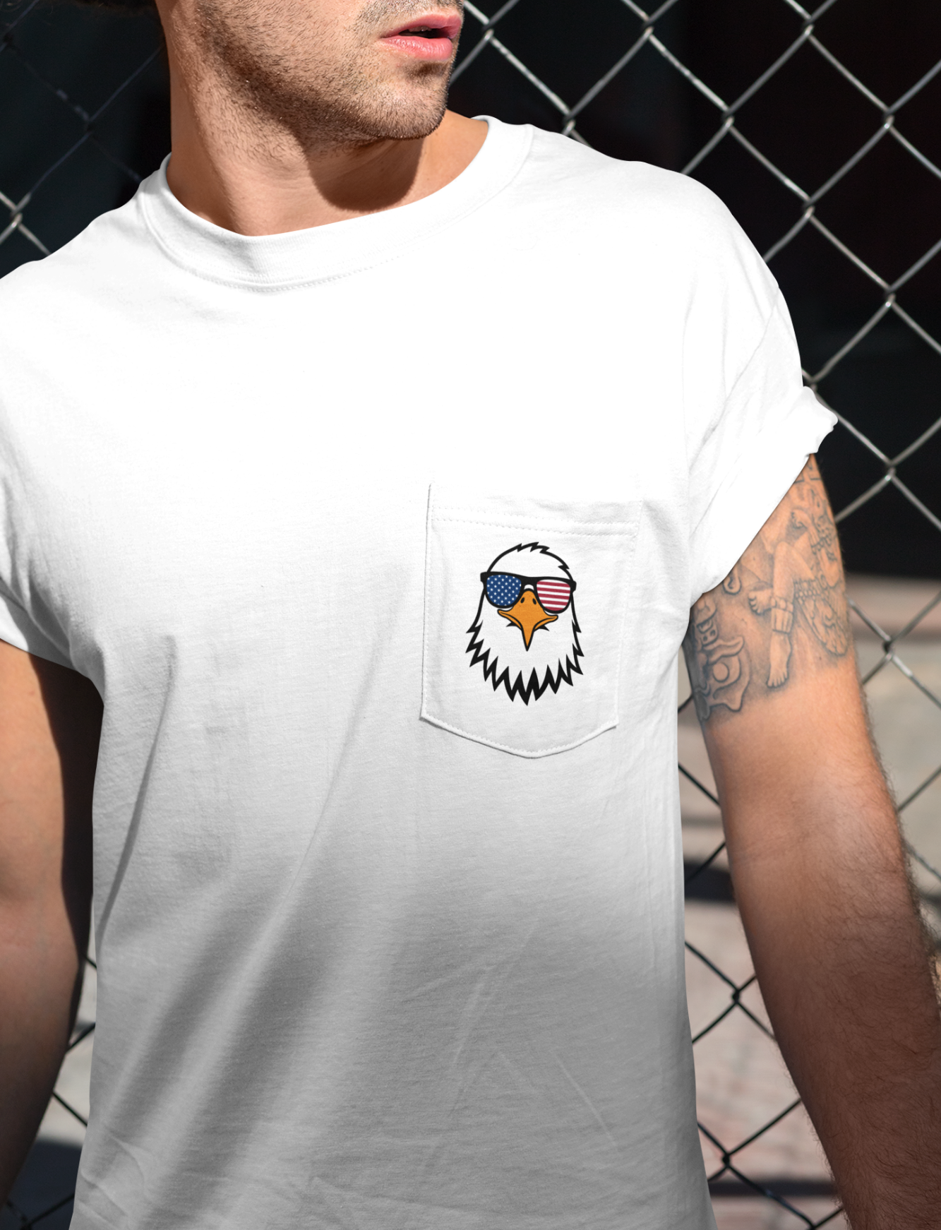 On the front of this custom t-shirt is a image of a bald eagle wearing a pair of sunglasses that have the American flag in the lenses.