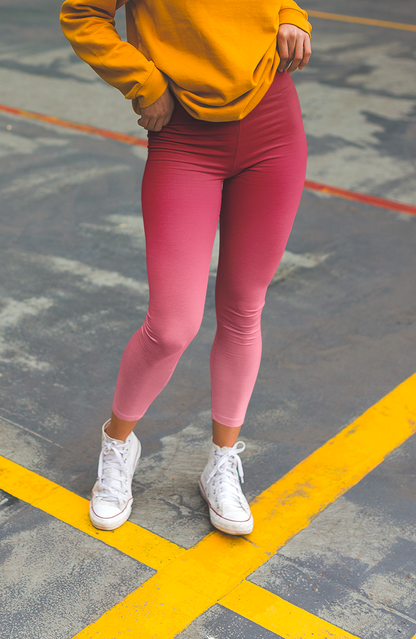 These custom handmade women's high waisted leggings have a pink ombre design with the top of the pants being a dark pink then it fading to a light baby pink at the ankles of the pants.