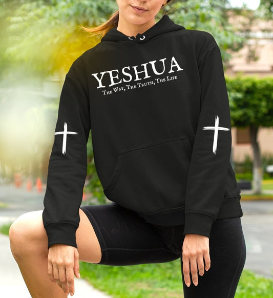 A oversized hoodie, on the front of the hoodie in white are the words Yeshua the same today tomorrow and forever in a old style font, there is also a white Jesus cross on both sleeves of the hooded sweater