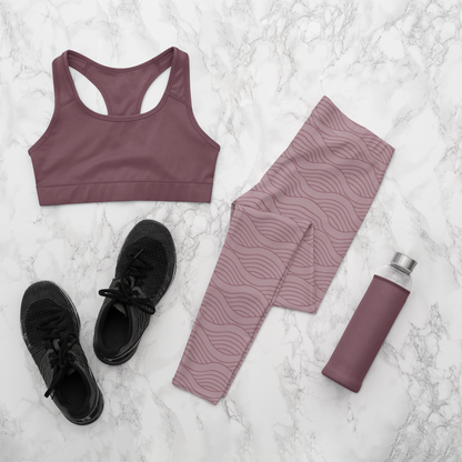 A pair of women's high waisted custom handmade leggings that are a light mauve in color, there are wavy lines throughout the pants that is a deep rose color.