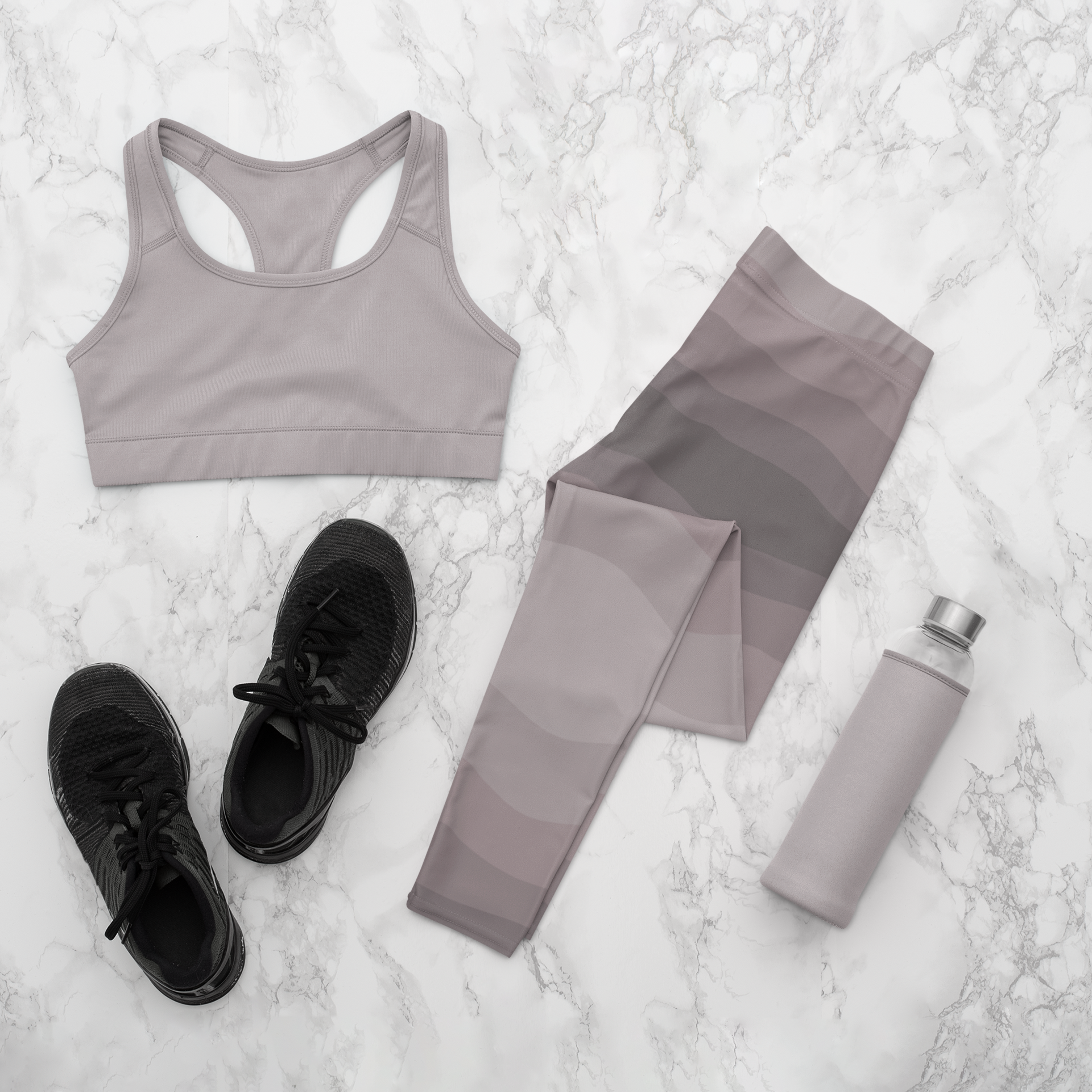 Custom high waisted women's leggings that have a wavy lines pattern that are all different shades of grey.