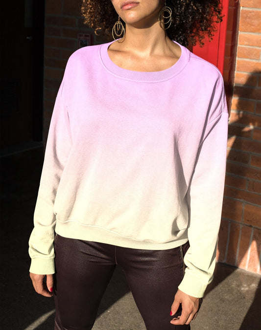 This custom women's sweater has a bright ombre pattern with the top of the pullover being a baby pink color then the sweater fading to a bright yellow color at the bottom.