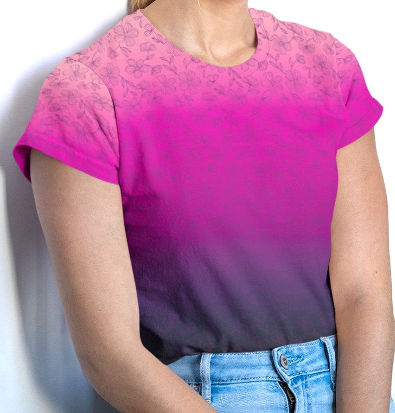 This super soft custom handmade women's tee features an ombre floral design with the top of the shirt being a bright peach color then it fading to a hot pink then it fades to a dark purple at the very bottom of the shirt, there is a dark purple floral pattern overlayed on top then fades into the bottom of the shirt.