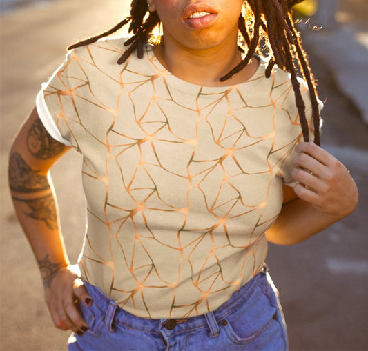 This all over print handmade women's custom t-shirt is beige all over with copper lines that go in a abstract pattern, the copper lines shine more in some places then in others giving it a metallic look.