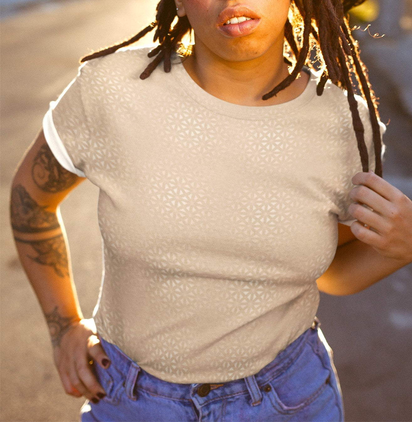 This super soft handmade custom women's shirt is a light beige color with even lighter metallic lines overlayed overtop, it looks like a floral pattern across the entire shirt.