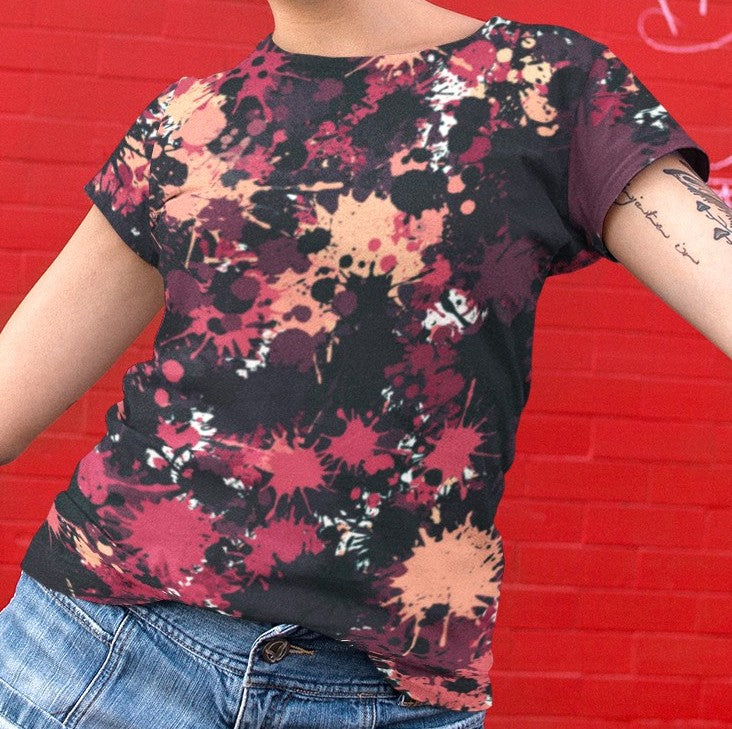 This completely custom super soft handmade women's t-shirt is all black with a bunch of different color paint splashes all over the shirt from red, pink, peach, burgundy, maroon and white. This shirt is perfect for painters or people who love art