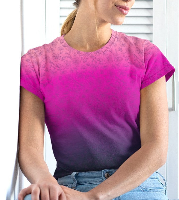 This super soft custom handmade women's tee features an ombre floral design with the top of the shirt being a bright peach color then it fading to a hot pink then it fades to a dark purple at the very bottom of the shirt, there is a dark purple floral pattern overlayed on top then fades into the bottom of the shirt.