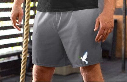These custom men's board shorts feature a unique design with a ombre pattern starting with a light grey at the top then fading to a dark grey at the bottom, there is a symbol of a dove carrying a fig leaf on the front left side of the shorts just at the knee.
