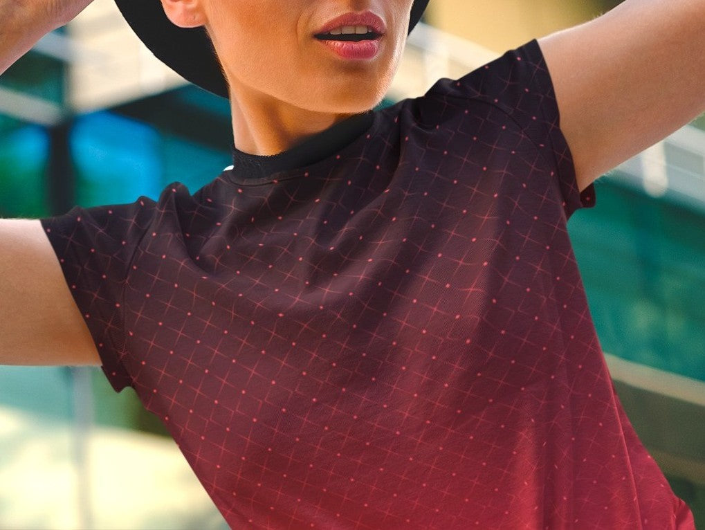 This completely custom women's shirt has a ombre pattern with it starting as a deep crimson red at the neckline of the shirt then fading to a bright red at the waistline, there is a crisscross pattern overlayed on the top in a light red color that makes the design look like it is glowing.