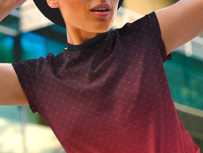 This completely custom women's shirt has a ombre pattern with it starting as a deep crimson red at the neckline of the shirt then fading to a bright red at the waistline, there is a crisscross pattern overlayed on the top in a light red color that makes the design look like it is glowing.