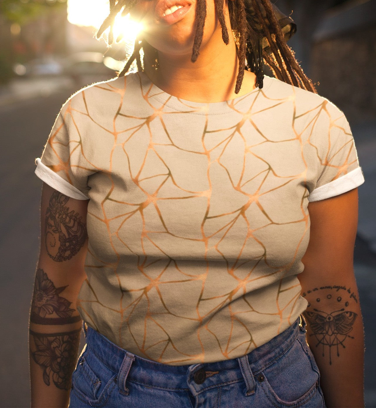 This all over print handmade women's custom t-shirt is beige all over with copper lines that go in a abstract pattern, the copper lines shine more in some places then in others giving it a metallic look.