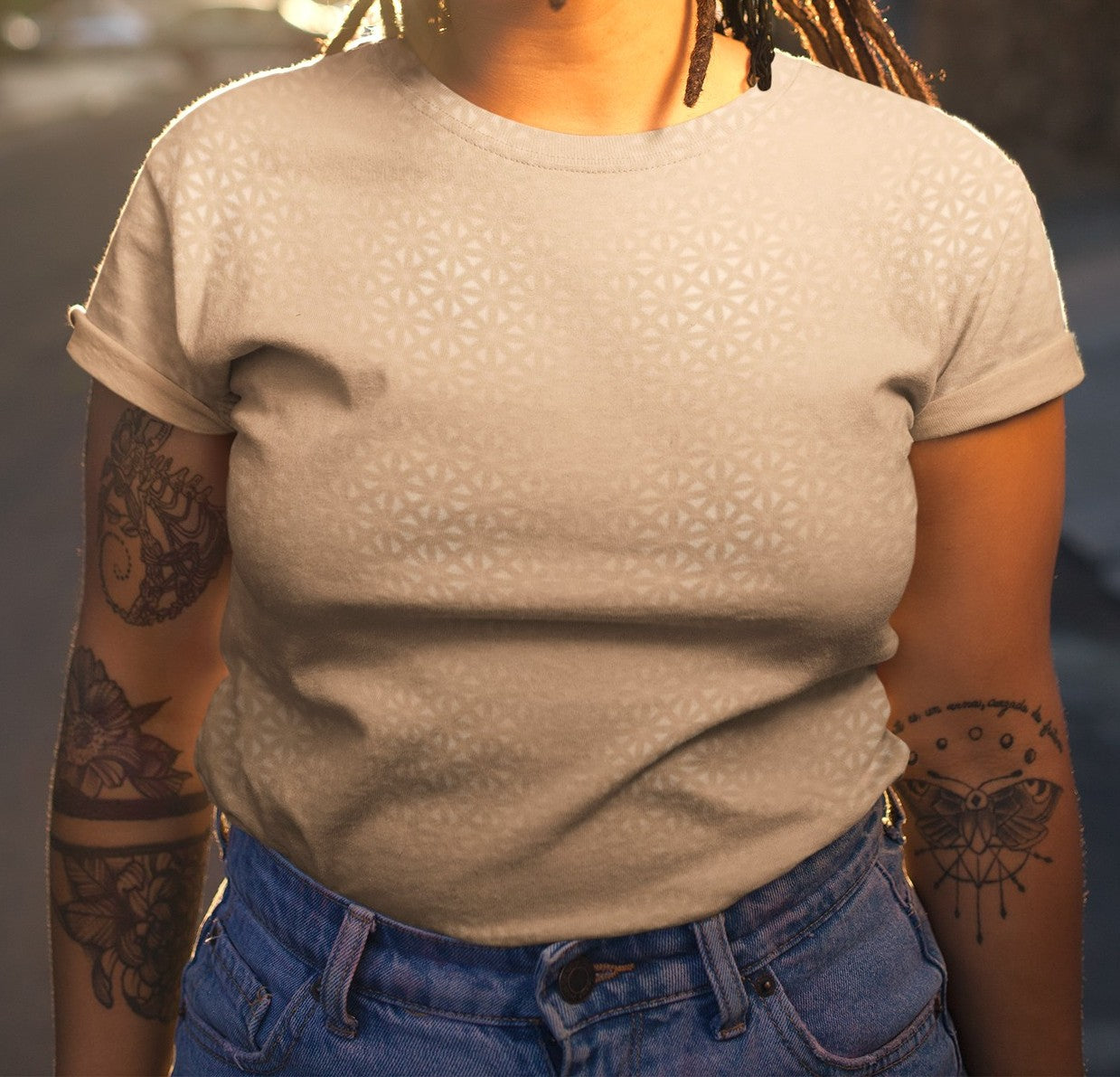 This super soft handmade custom women's shirt is a light beige color with even lighter metallic lines overlayed overtop, it looks like a floral pattern across the entire shirt.