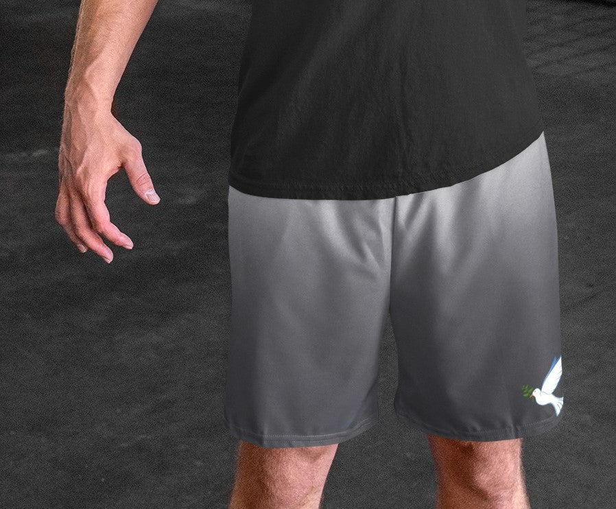 These custom men's board shorts feature a unique design with a ombre pattern starting with a light grey at the top then fading to a dark grey at the bottom, there is a symbol of a dove carrying a fig leaf on the front left side of the shorts just at the knee.