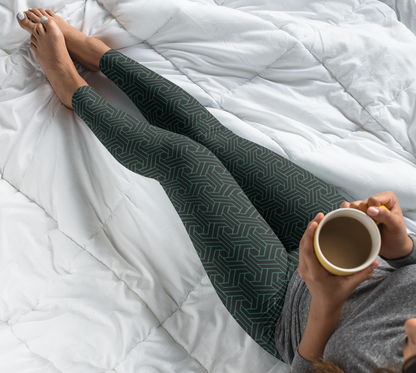 These custom handmade women's high waisted leggings are black in color with a glowing green geometric pattern overlayed on the top.