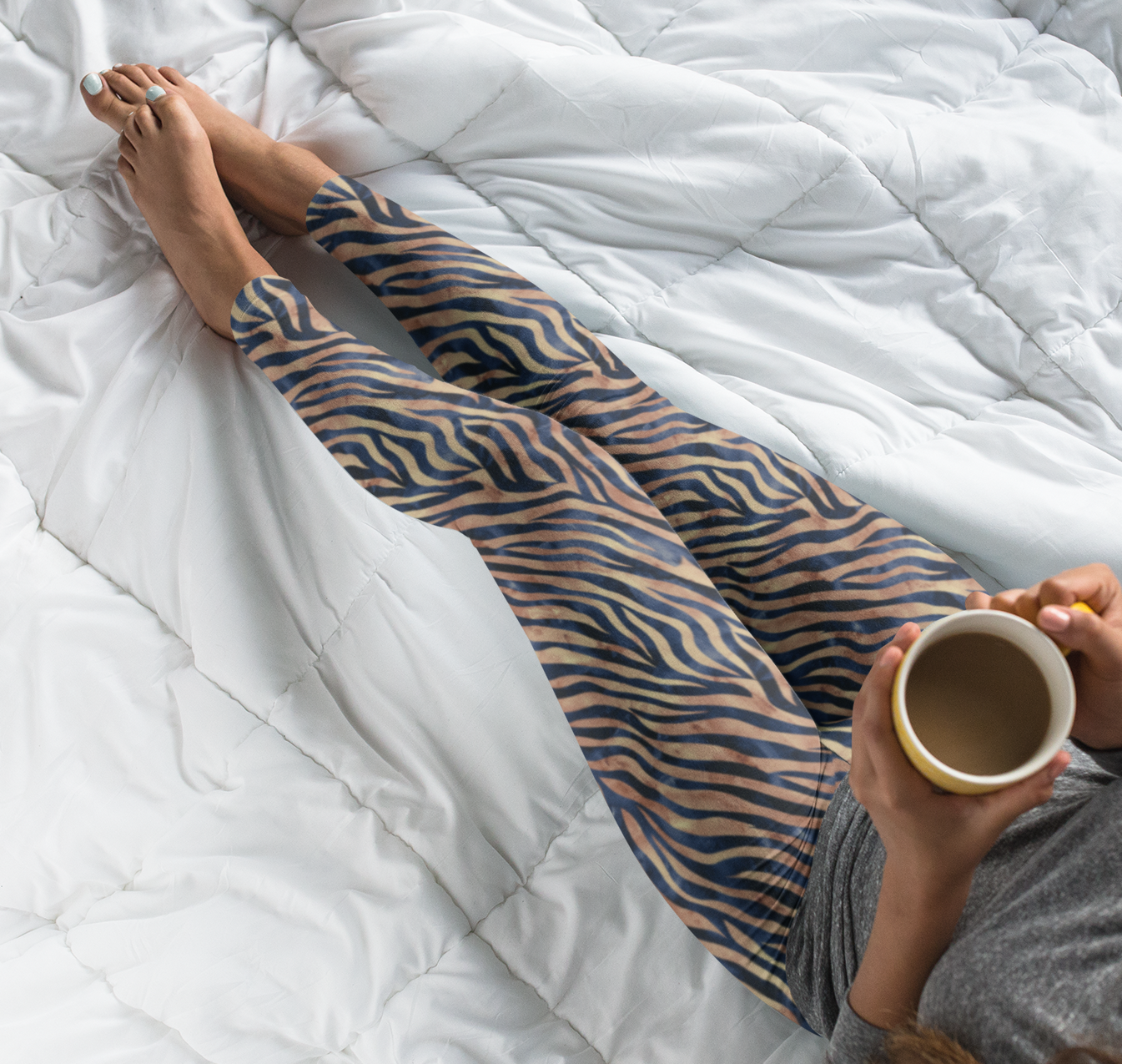 Custom women's high waisted leggings that are beige in color with black lines overtop that look like animal print like that of tigers.