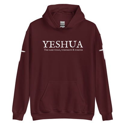 A custom handmade unisex Christian hooded sweater, on the front of the hoodie in white are the words Yeshua the same today, tomorrow and forever in an old style font, there is also a white Jesus cross on both sleeves of the hooded sweater right at the elbows.