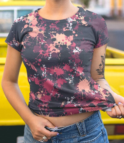 This completely custom super soft handmade women's t-shirt is all black with a bunch of different color paint splashes all over the shirt from red, pink, peach, burgundy, maroon and white. This shirt is perfect for painters or people who love art